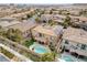 Aerial view of a home featuring backyard oasis with pool, complemented by desert landscaping and solar panels for energy efficiency at 12116 Vista Linda Ave, Las Vegas, NV 89138