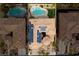 Stunning aerial view of a property featuring a private pool, lush landscaping, and solar panels for energy efficiency at 12116 Vista Linda Ave, Las Vegas, NV 89138