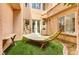 Serene backyard oasis with a relaxing hammock, artificial turf, and lush landscaping creating a private retreat at 12116 Vista Linda Ave, Las Vegas, NV 89138