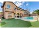 Lush backyard offering a pristine pool, artificial turf, and a covered patio with easy access to indoor living at 12116 Vista Linda Ave, Las Vegas, NV 89138