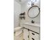 Charming bathroom features include a round mirror, shiplap wall, and black hardware at 12116 Vista Linda Ave, Las Vegas, NV 89138