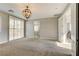 Bright bedroom with plantation shutters, carpet floors, and elegant lighting fixture at 12116 Vista Linda Ave, Las Vegas, NV 89138