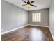 This bedroom offers hardwood floors, neutral walls, ceiling fan, and window with plantation shutters at 12116 Vista Linda Ave, Las Vegas, NV 89138