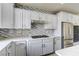 This spacious kitchen features white cabinets, tile backsplash, quartz countertops, and stainless steel appliances at 12116 Vista Linda Ave, Las Vegas, NV 89138