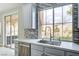 Bright kitchen features white cabinets, quartz countertops, stainless steel appliances and backyard view at 12116 Vista Linda Ave, Las Vegas, NV 89138