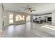 Spacious living room area with hardwood flooring, fireplace, ceiling fan, and easy access to backyard at 12116 Vista Linda Ave, Las Vegas, NV 89138