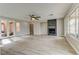 Bright living room with a fireplace, hardwood flooring, ceiling fan, and natural light at 12116 Vista Linda Ave, Las Vegas, NV 89138