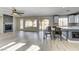 Open-concept living room featuring a modern fireplace, hardwood floors, and seamless flow to the kitchen and outdoor spaces at 12116 Vista Linda Ave, Las Vegas, NV 89138
