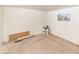 Unfinished basement ready for customization, with a window and necessary building materials at 1436 Chestnut St, Henderson, NV 89011