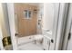 This remodeled bathroom has modern gold fixtures, marbled tile, a new vanity, and toilet at 1436 Chestnut St, Henderson, NV 89011
