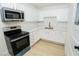 Updated kitchen with stainless steel appliances, stone countertops, and ample cabinet space at 1436 Chestnut St, Henderson, NV 89011