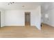 Open concept living room showing updated kitchen and luxury vinyl plank flooring at 1436 Chestnut St, Henderson, NV 89011
