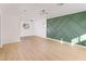 Spacious living room with luxury vinyl plank flooring and modern accent wall at 1436 Chestnut St, Henderson, NV 89011