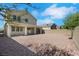 Spacious backyard with covered patio, gravel landscaping and privacy fence offers an outdoor living area at 152 Walkinshaw Ave, Las Vegas, NV 89148