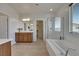 Bright bathroom featuring a luxurious tub, walk-in shower, double vanity, and ample natural light at 152 Walkinshaw Ave, Las Vegas, NV 89148
