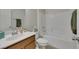 Clean bathroom featuring a single sink vanity with a wood finish, shower over tub combination, and modern fixtures at 152 Walkinshaw Ave, Las Vegas, NV 89148