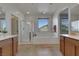 Bright bathroom showcasing a glass shower, tub, double vanity, and plenty of natural light at 152 Walkinshaw Ave, Las Vegas, NV 89148