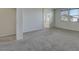 Large bedroom with neutral walls, gray carpet, and a window that provide natural light at 152 Walkinshaw Ave, Las Vegas, NV 89148