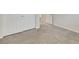 A cozy, carpeted bedroom with neutral paint and plush carpet, double door closet, and a glimpse of natural light from the door way at 152 Walkinshaw Ave, Las Vegas, NV 89148