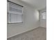 Bedroom featuring neutral walls, gray carpet and multiple windows for natural light at 152 Walkinshaw Ave, Las Vegas, NV 89148