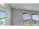 Bedroom featuring neutral walls, carpet and multiple windows for natural light with view of the exterior at 152 Walkinshaw Ave, Las Vegas, NV 89148