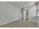 Bedroom featuring neutral walls, gray carpet, and closet with shelving for storage at 152 Walkinshaw Ave, Las Vegas, NV 89148