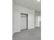 Bedroom featuring neutral walls, gray carpet, and closet with shelving for storage at 152 Walkinshaw Ave, Las Vegas, NV 89148