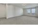 Large bonus room featuring neutral carpeting and bright natural light from windows at 152 Walkinshaw Ave, Las Vegas, NV 89148