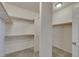 Walk-in closet featuring built-in shelving, providing ample storage and organization space at 152 Walkinshaw Ave, Las Vegas, NV 89148
