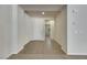 Bright foyer with tile flooring transitions to plush carpet, freshly painted walls, and a conveniently located thermostat at 152 Walkinshaw Ave, Las Vegas, NV 89148