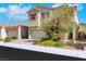 Charming two-story home featuring a brick driveway, stucco exterior, well-manicured landscaping, and an attached two-car garage at 152 Walkinshaw Ave, Las Vegas, NV 89148