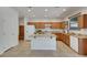 Stylish kitchen featuring a center island, stainless appliances, and bright lighting at 152 Walkinshaw Ave, Las Vegas, NV 89148