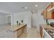 Bright kitchen featuring an island with granite countertop and modern appliances at 152 Walkinshaw Ave, Las Vegas, NV 89148