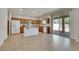 Bright kitchen with island, stainless appliances, and sliding glass door at 152 Walkinshaw Ave, Las Vegas, NV 89148
