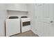Clean laundry room with modern washer and dryer units and a white door at 152 Walkinshaw Ave, Las Vegas, NV 89148