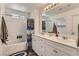 Bathroom featuring double sinks, white cabinets, and a shower/tub with a white subway tile surround at 1611 Prairie Fields Ct, Las Vegas, NV 89115