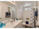 Bright bathroom featuring a single sink vanity, tub with shower, and coordinated decor at 1611 Prairie Fields Ct, Las Vegas, NV 89115