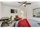 Relaxing bedroom with a ceiling fan, television, desk, carpeted floors, and an ensuite bathroom at 1611 Prairie Fields Ct, Las Vegas, NV 89115