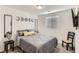 A well-lit bedroom showcasing stylish moon decor above the bed and a sleek, modern design at 1611 Prairie Fields Ct, Las Vegas, NV 89115