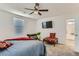 Comfortable bedroom featuring a ceiling fan, a bed, a desk and carpeted floors at 1611 Prairie Fields Ct, Las Vegas, NV 89115