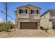 Inviting two-story home with a spacious two-car garage and desert landscaping at 1611 Prairie Fields Ct, Las Vegas, NV 89115