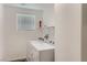 A functional laundry area equipped with a washer, dryer, and shelving for storage at 1611 Prairie Fields Ct, Las Vegas, NV 89115