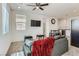 The living room features a ceiling fan and two windows, open to the kitchen area at 1611 Prairie Fields Ct, Las Vegas, NV 89115