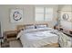 Cozy bedroom with a wood bed frame, stylish furnishings and white bedding at 1624 N Torrey Pines Dr # 101, Las Vegas, NV 89108