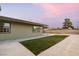A large backyard area features a patio and a newly installed grass lawn along the fence at 1628 Izabella Ave, Las Vegas, NV 89169