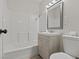 Clean, modern bathroom with shower-tub combo, gray vanity, and white toilet at 1628 Izabella Ave, Las Vegas, NV 89169