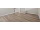This bedroom features sleek wood flooring, bright white walls, and white baseboards at 1628 Izabella Ave, Las Vegas, NV 89169