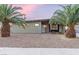 Quaint single-story home with desert landscaping and mature palm trees at 1628 Izabella Ave, Las Vegas, NV 89169