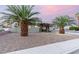 Charming home features mature palm trees and a well-maintained yard at 1628 Izabella Ave, Las Vegas, NV 89169