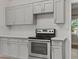 Modern kitchen featuring stainless steel appliances, sleek countertops, and ample cabinet space at 1628 Izabella Ave, Las Vegas, NV 89169